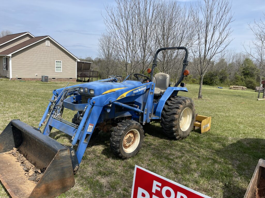 Tractor with front loader and box scraper equipment rental